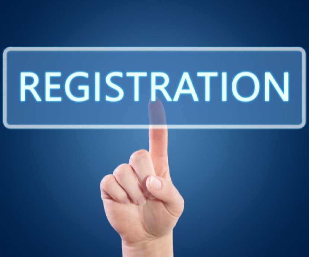 Hand pointing at a REGISTRATION sign